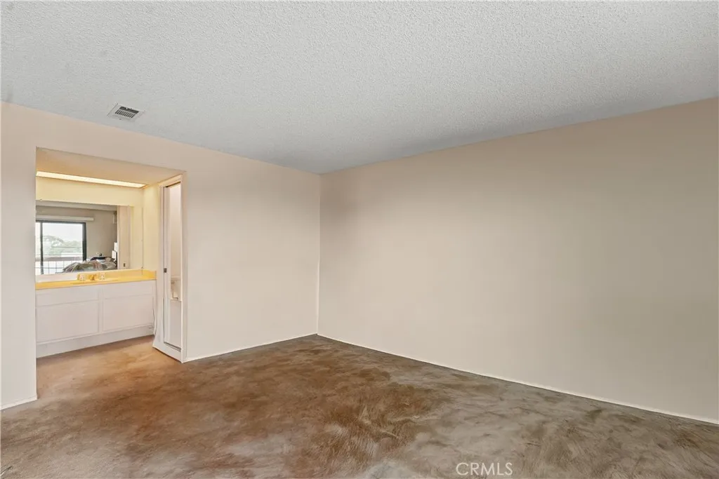 Empty Primary looking into bathroom
