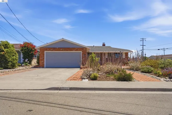 Single-story residence featuring a brick facade and an attached garage