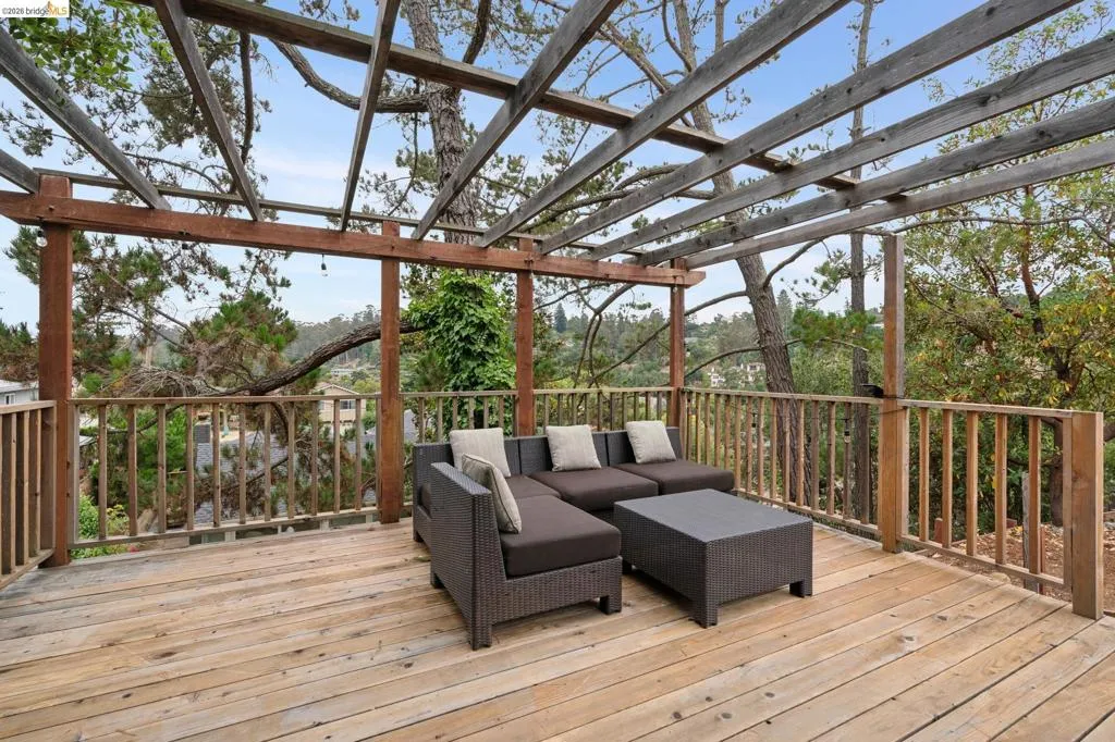 Wood-finish deck featuring a slatted pergola structure