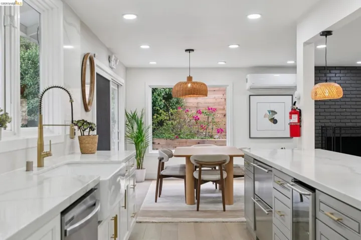 Kitchen featuring a farmhouse sink with a gold-tone faucet, white countertops, built-in dishwasher, and recessed lighting