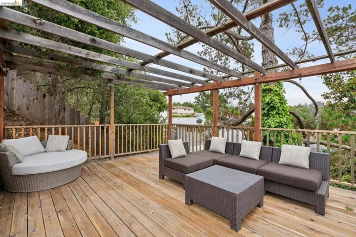 Expansive wood deck featuring a slatted pergola overhead