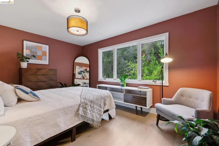 Spacious room with light wood-finish flooring and a multi-pane window