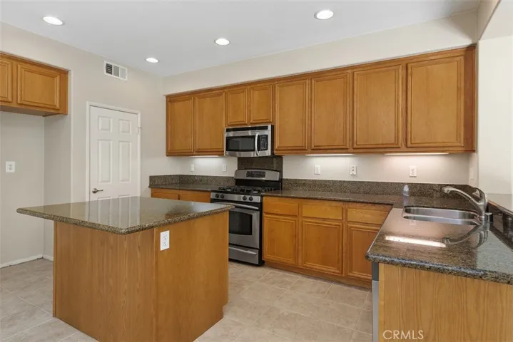 Kitchen has Granite Counter Tops