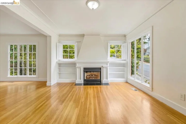 Living area featuring a central fireplace with a black surround and white mantel