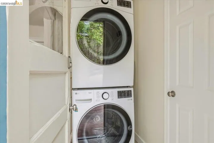 Dedicated laundry area featuring a stacked washer and dryer unit