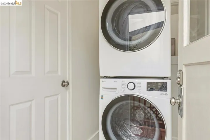 White stacked washer and dryer unit with digital displays and front-loading doors