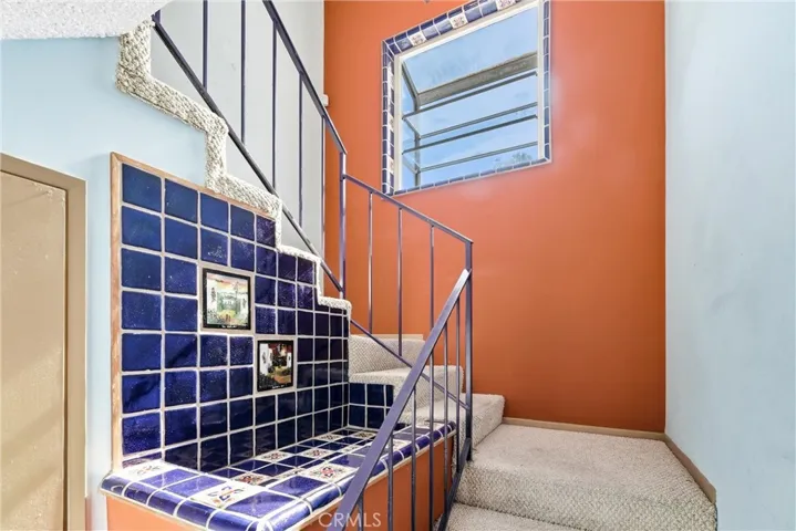 Staircase with window view of backyard
