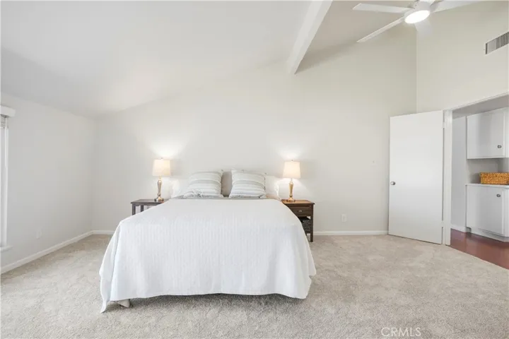 The primary suite features vaulted ceilings, new carpet and ceiling fan.