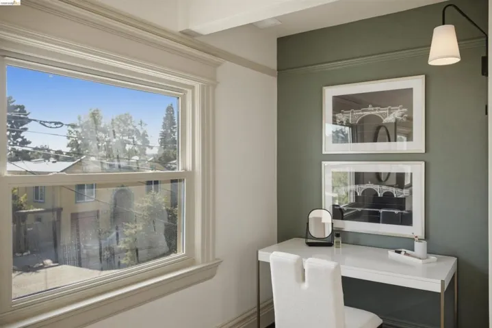 Double-hung window framed by detailed trimwork
