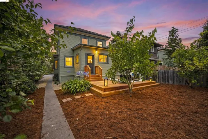 Two-story exterior with light green siding and dark trim