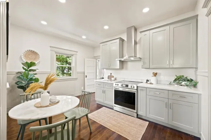 Modern kitchen featuring light gray cabinetry, white countertops, stainless steel appliances, and recessed lighting