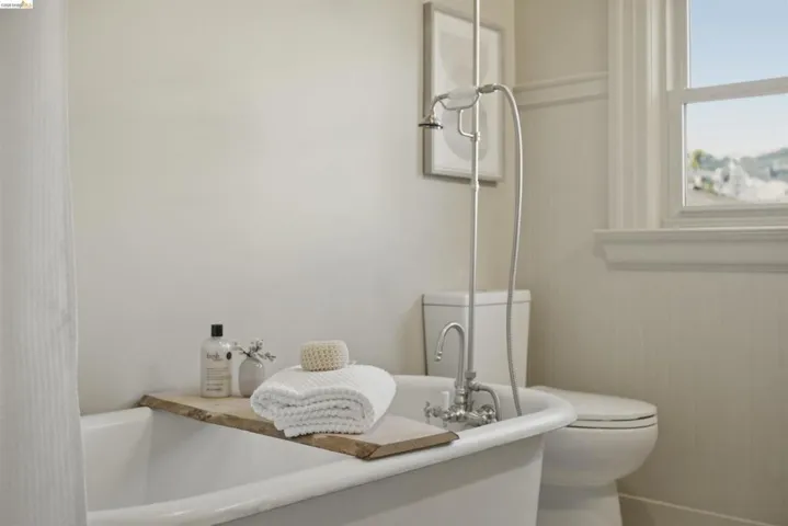Freestanding clawfoot tub with a floor-mounted faucet and shower fixture