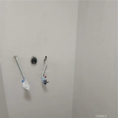 Washer/dryer hook-ups in hall.