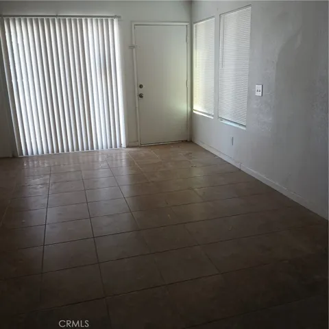 Living room.  Unit is completely tiled except for two bedrooms.