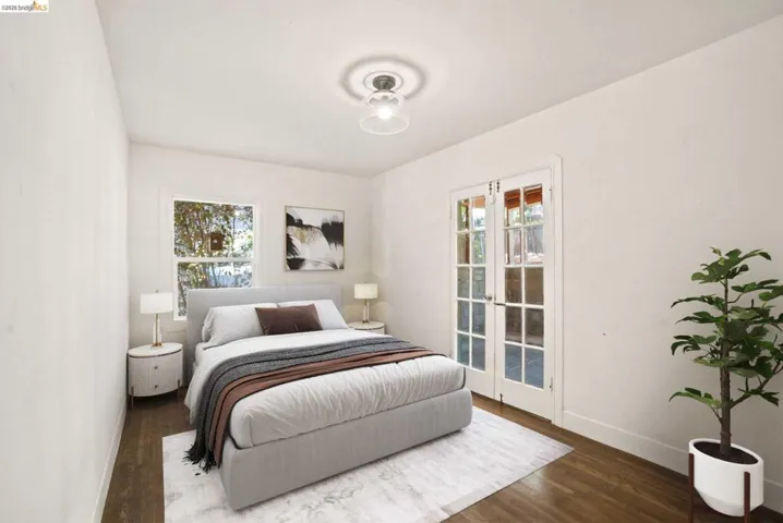 Hardwood flooring throughout, bright white walls, and a contemporary ceiling light fixture