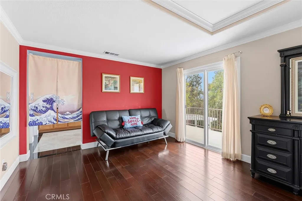 Primary suite with sitting area and balcony with view.