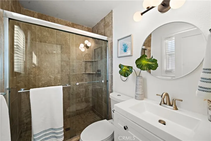 Downstairs primary suite bathroom with tiled walk-in shower