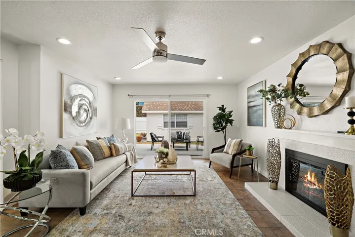 Living room with fireplace, recessed lighting, title flooring, and slider leading to backyard