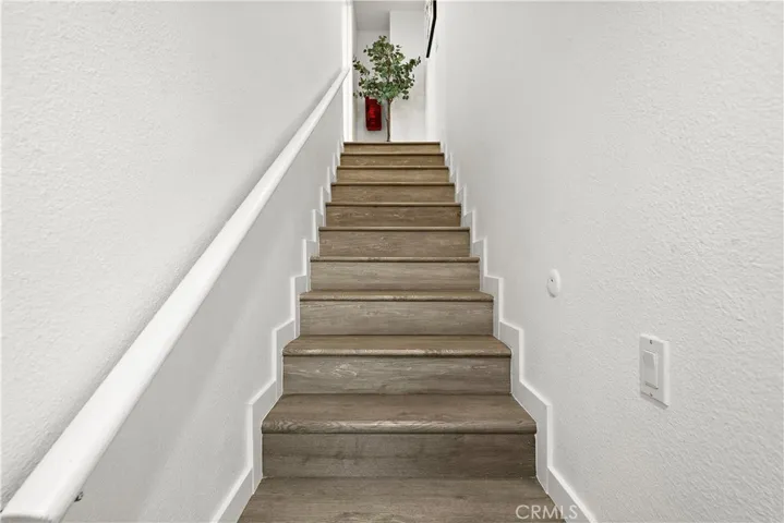 Staircase leading to upstairs bedroom #4 - a second primary suite that was a 400 square foot bonus room
