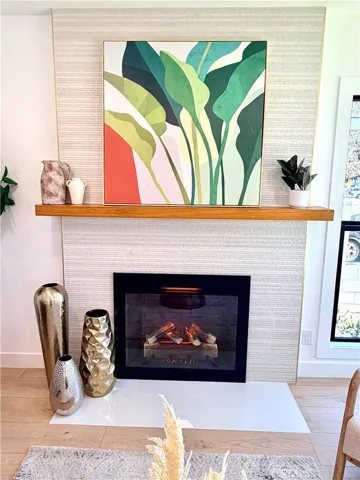 Brilliantly updated fireplace with rich tile and electric fireplace insert.