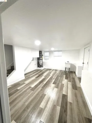 Open finished lower level with wood-finish flooring