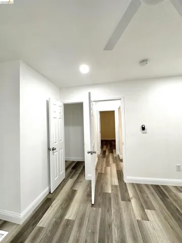 Wood-finish flooring throughout, complemented by crisp white baseboards