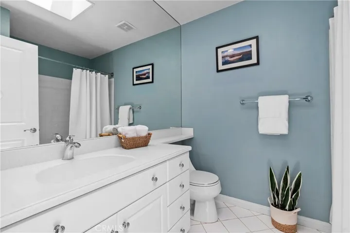 Guest Bathroom ~ Full bath with tub & shower overhead...updated vanity & sink with quartz countertop and fabulous skylight! to illuminate the bathroom~