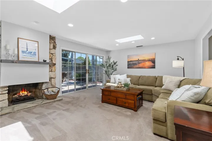 An attractive natural stone fireplace and mantel and recessed lighting overlooking the enchanting patio area~