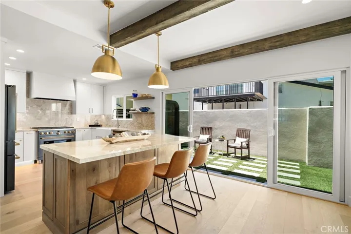 Kitchen opening to side yard for al fresco dining
