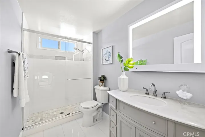 Upstairs remodeled bathroom with walk in shower and LED mirror