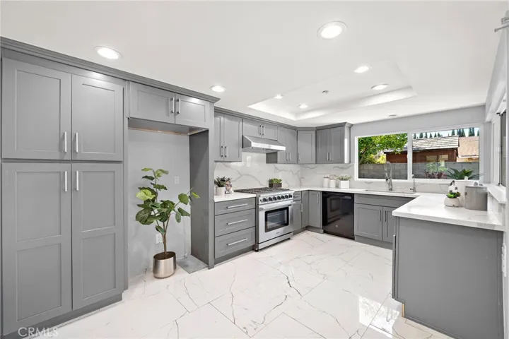 The remodeled kitchen features stainless steel appliances, abundant cabinetry