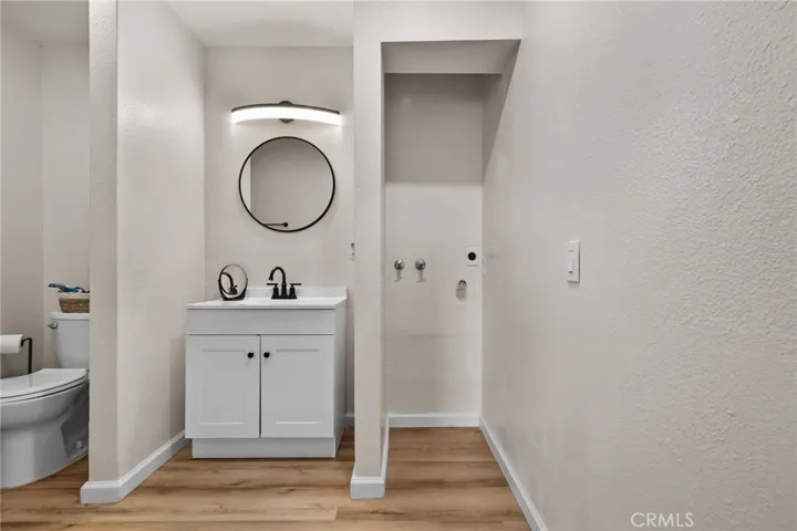 Updated bath with indoor laundry hookup and modern black fixtures.