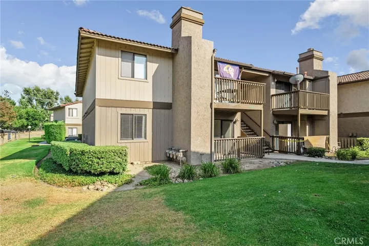Ground-floor end-unit condo offering added privacy. Surrounded by mature landscaping and lush hedges, opens onto a spacious shared green space.