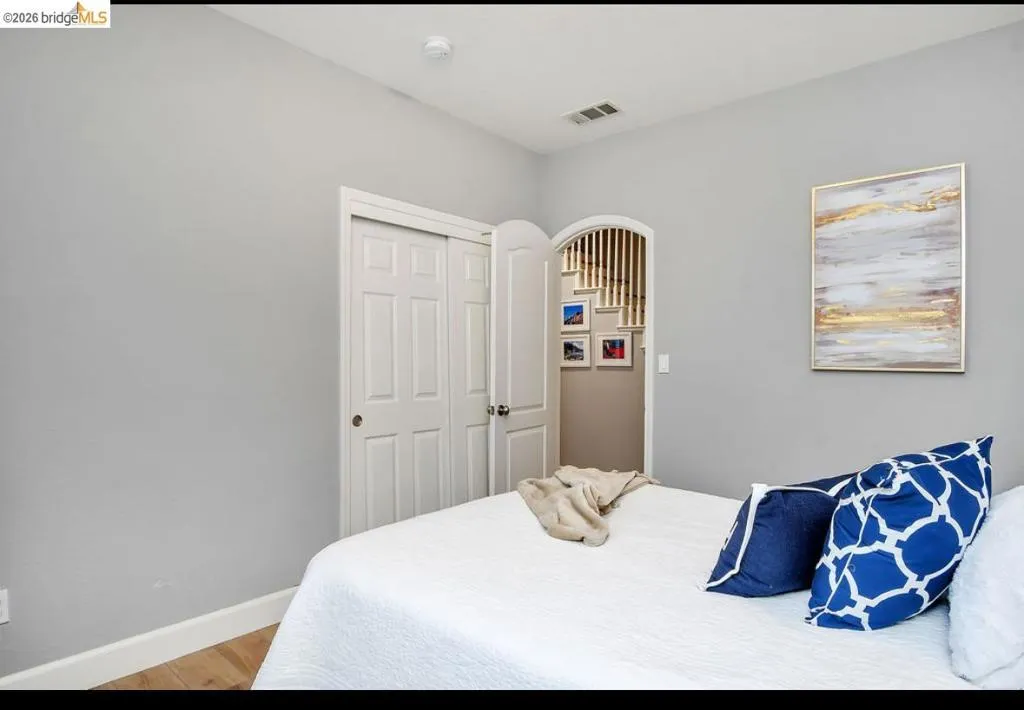 Bedroom with light wood-style flooring and a closet
