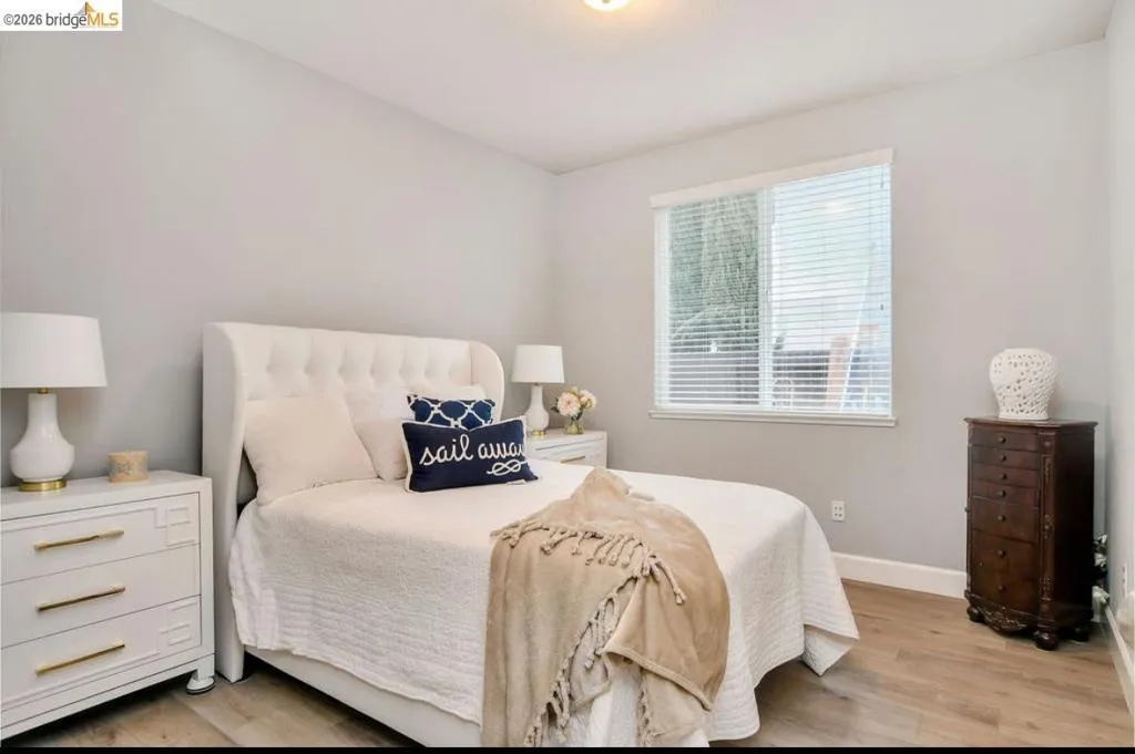 Bedroom with light wood-type flooring and baseboards