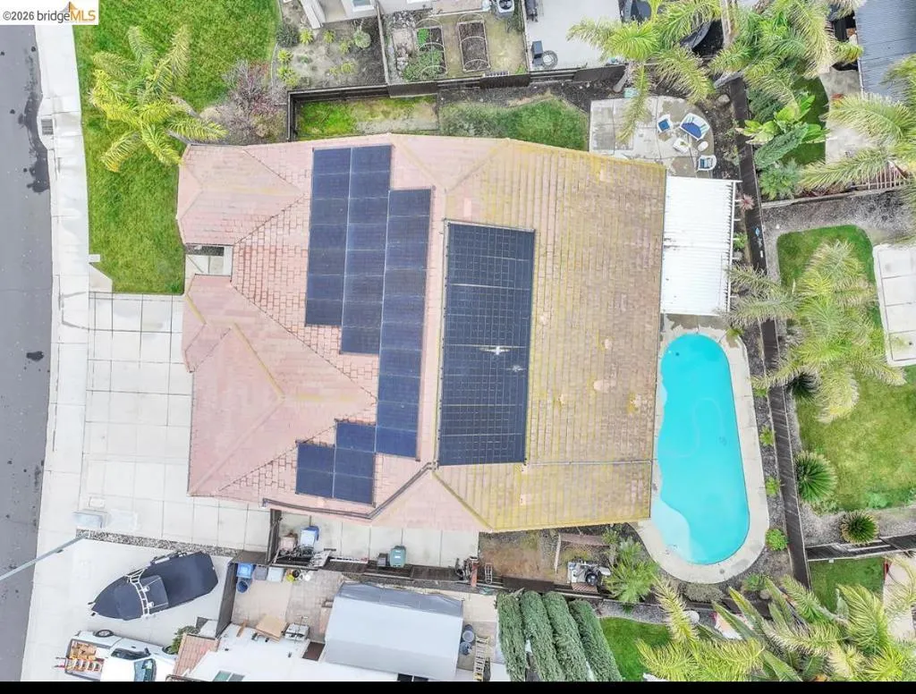 Aerial view of property and surrounding area featuring a pool
