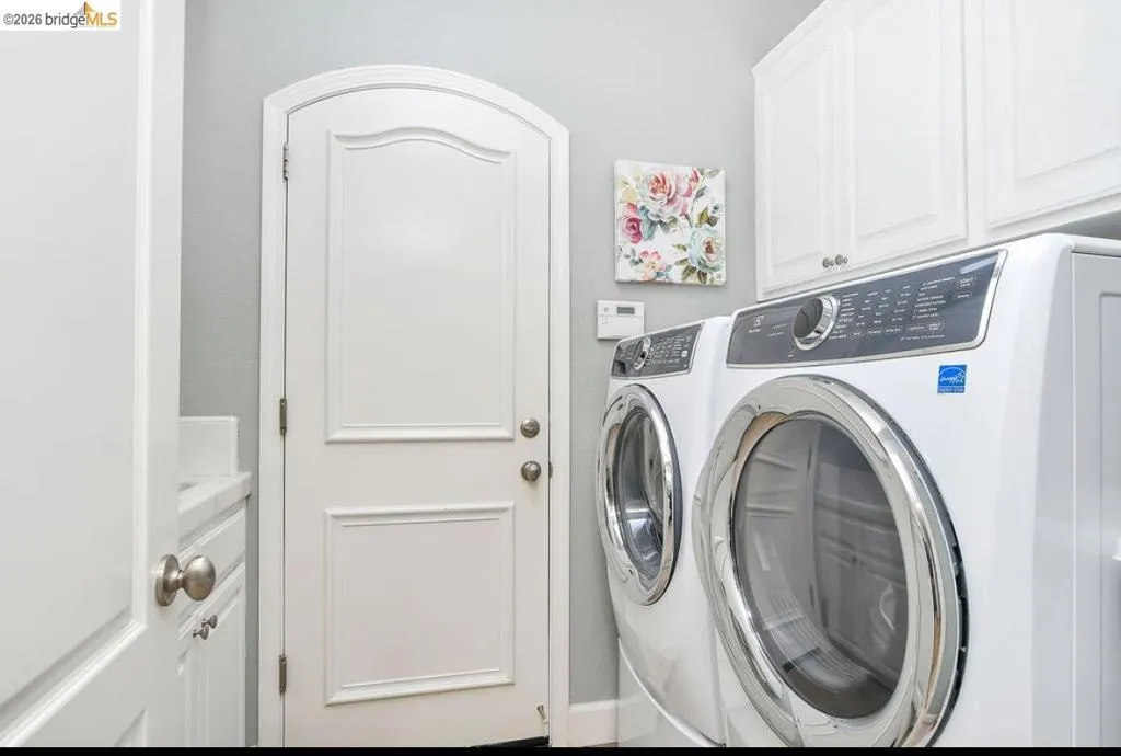 Washroom with cabinet space and independent washer and dryer