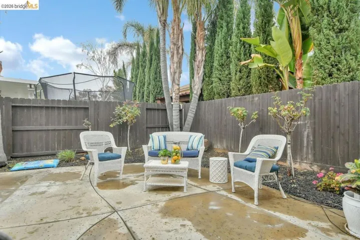 Fenced backyard featuring a patio and an outdoor hangout area