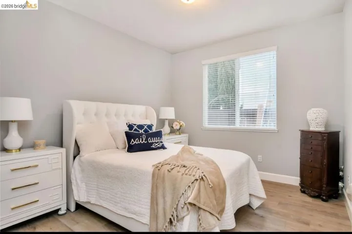 Bedroom with light wood-type flooring and baseboards