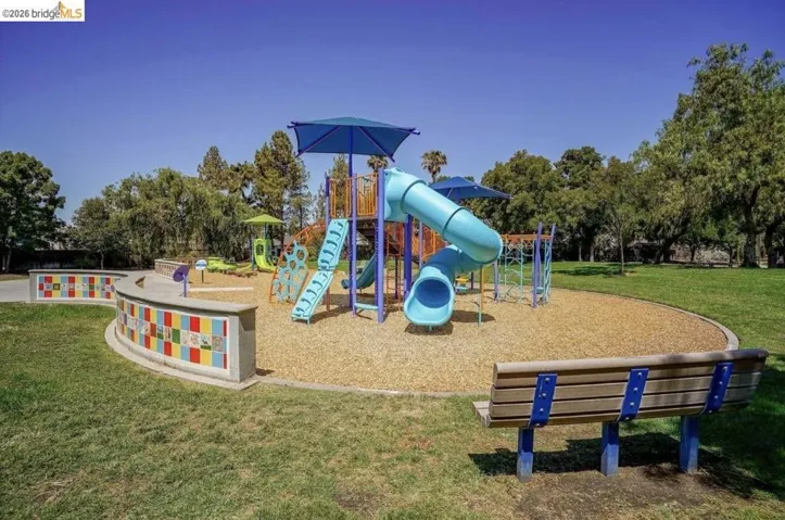 Community jungle gym featuring a yard and view of scattered trees