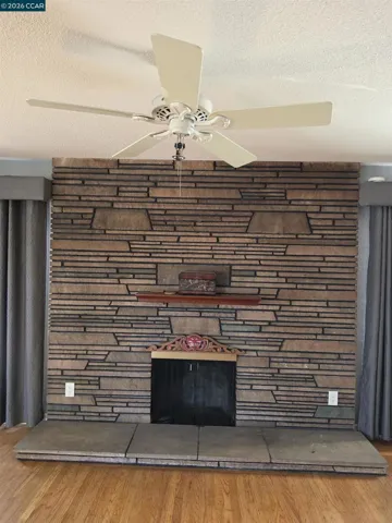 Mid-century modern stone fireplace anchors the living room.