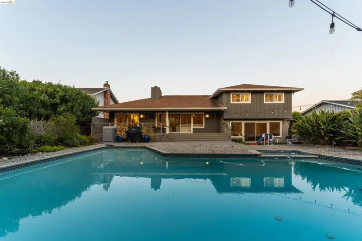 Expansive swimming pool featuring a tiled perimeter and integrated spa