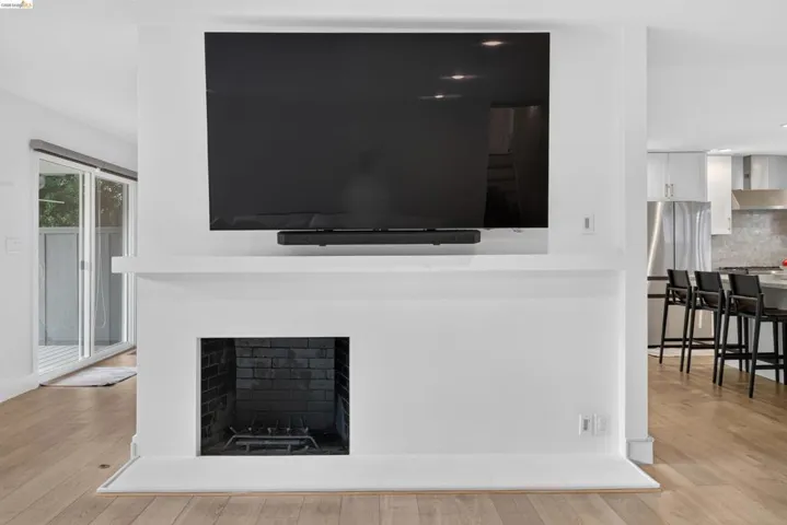Modern fireplace feature with a black brick firebox and white mantel