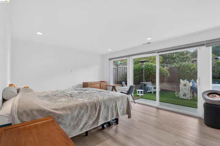Interior space with light wood-finish flooring and recessed lighting
