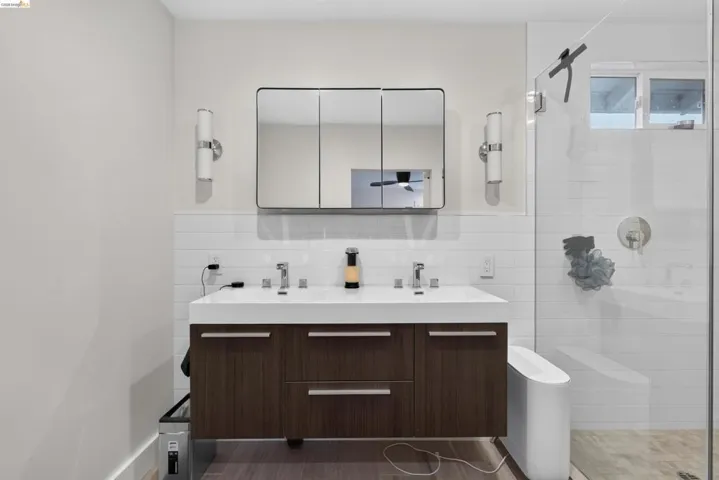 Double vanity with dark wood-finish cabinetry and rectangular sinks