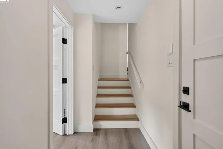Staircase featuring wood treads and white risers