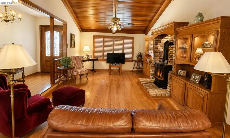 Hardwood flooring throughout featuring a wood-paneled ceiling with exposed beams