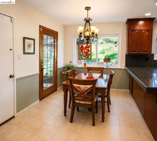 Bright eat-in kitchen with ceramic tile flooring