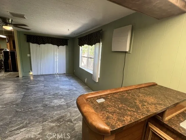 VIEW FROM WET BAR INTO DEN/FAMILY RM