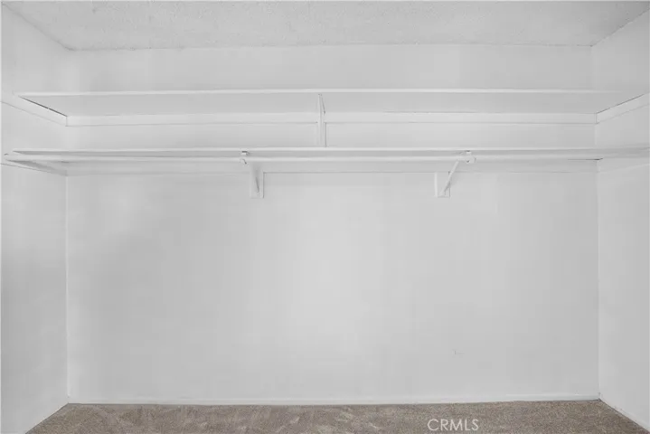 Behind Mirrored Doors is this huge Walk-In Closet